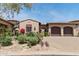 Charming home with a desert landscape, a private drive, and a three-car garage at 8974 E Rusty Spur Pl, Scottsdale, AZ 85255