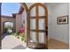 Charming front door with decorative glass and a view of the lush desert landscape beyond at 8974 E Rusty Spur Pl, Scottsdale, AZ 85255