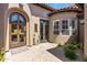 Inviting front entrance with a custom wood door, stone pavers, and desert landscaping at 8974 E Rusty Spur Pl, Scottsdale, AZ 85255