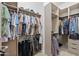 Spacious walk-in closet with custom shelving, ample hanging space, and built-in drawers at 8974 E Rusty Spur Pl, Scottsdale, AZ 85255