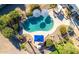 Aerial view of a private backyard oasis with a sparkling pool, lush landscaping, and shaded lounging areas at 9035 W Villa Chula --, Peoria, AZ 85383