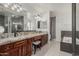 Modern bathroom featuring granite countertops, dark wood cabinets and a soaking tub at 9035 W Villa Chula --, Peoria, AZ 85383