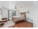 Charming bedroom with natural light, ceiling fan, and warm wood floors at 9035 W Villa Chula --, Peoria, AZ 85383