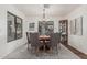 Inviting dining room features a round wooden table, tufted chairs, and a stylish chandelier over a patterned rug at 9035 W Villa Chula --, Peoria, AZ 85383