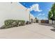 The backyard features a private drive and fence, with verdant green bushes creating a barrier at 9035 W Villa Chula --, Peoria, AZ 85383