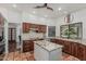 Elegant kitchen with wooden cabinetry, granite countertops, tile backsplash and flooring at 9035 W Villa Chula --, Peoria, AZ 85383