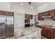 Well-equipped kitchen with stainless steel appliances, granite countertops, and custom wood cabinetry at 9035 W Villa Chula --, Peoria, AZ 85383