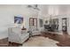 Bright living room featuring hardwood floors, comfortable seating, and an adjacent dining area with modern lighting at 9035 W Villa Chula --, Peoria, AZ 85383