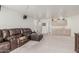 Open-concept living room featuring a large, worn leather sofa and a wet bar area with cabinetry at 9035 W Villa Chula --, Peoria, AZ 85383