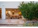 Outdoor patio featuring an outdoor dining set and lush landscaping at 9035 W Villa Chula --, Peoria, AZ 85383