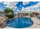 Refreshing pool with rock waterfall feature, inviting lounge area, and a lush tropical setting at 9035 W Villa Chula --, Peoria, AZ 85383