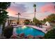 Inviting backyard pool with rock features, lush landscaping, and a cozy cabana area at 9035 W Villa Chula --, Peoria, AZ 85383