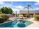 Sparkling pool with lounge area, tropical landscaping, and backyard privacy fencing at 9035 W Villa Chula --, Peoria, AZ 85383