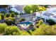 Aerial view of backyard oasis with a sparkling pool, rock waterfall, mature palms and lush landscaping at 9035 W Villa Chula --, Peoria, AZ 85383