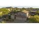 Aerial view of a suburban home and backyard featuring lush green trees and mountain views on a clear day at 9517 E Minton St, Mesa, AZ 85207