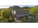 Stunning aerial view of the home, highlighting a landscaped yard, fire pit, and mountain views in the background at 9517 E Minton St, Mesa, AZ 85207