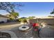 Inviting backyard featuring a stone fire pit and comfortable seating area, perfect for outdoor relaxation and entertaining at 9517 E Minton St, Mesa, AZ 85207