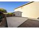 Spacious backyard featuring a large concrete pad, offering versatility for parking or outdoor activities at 9517 E Minton St, Mesa, AZ 85207
