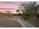Charming backyard with a stone fire pit, inviting seating, and a well-manicured walkway, ideal for evening relaxation at 9517 E Minton St, Mesa, AZ 85207