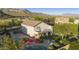 Aerial view of a home's backyard featuring a pool, patio, and lush green lawn set against a mountain backdrop at 9517 E Minton St, Mesa, AZ 85207
