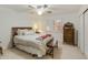 Bright bedroom featuring a ceiling fan, shuttered windows, and neutral carpet at 9517 E Minton St, Mesa, AZ 85207