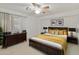 Inviting bedroom with neutral carpet, ceiling fan, shutters, and warm, inviting decor at 9517 E Minton St, Mesa, AZ 85207