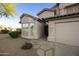 Front exterior view of a charming home with a desert landscape, walkway, and two-car garage at 9517 E Minton St, Mesa, AZ 85207