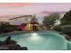 Beautiful pool and backyard, with lush landscaping, patio furniture and a view of the house in the background at 9517 E Minton St, Mesa, AZ 85207