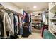 Organized walk-in closet with built-in shelves and ample hanging space for clothing and accessories at 9517 E Minton St, Mesa, AZ 85207