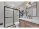 Updated bathroom featuring a glass-enclosed shower, white countertop, and stylish fixtures at 9807 N 5Th St, Phoenix, AZ 85020
