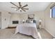 Bedroom featuring a fireplace, ceiling fan, neutral decor, and a cozy bed at 9807 N 5Th St, Phoenix, AZ 85020