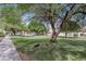 Well-maintained community green space featuring lush lawns, mature trees and walking paths at 9807 N 5Th St, Phoenix, AZ 85020