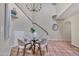 Bright dining room with chandelier, staircase, and terra-cotta tile flooring at 9807 N 5Th St, Phoenix, AZ 85020