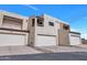 Stylish townhomes featuring private garages and contemporary architectural design under a bright blue sky at 9807 N 5Th St, Phoenix, AZ 85020