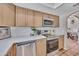 Updated kitchen with stainless steel appliances, quartz counters, and ample cabinet space at 9807 N 5Th St, Phoenix, AZ 85020