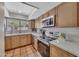 Updated kitchen with stainless steel appliances, quartz counters, and ample cabinet space at 9807 N 5Th St, Phoenix, AZ 85020