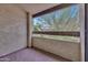 Outdoor patio with textured walls and views of the surrounding trees at 9807 N 5Th St, Phoenix, AZ 85020