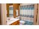 Cozy bathroom with a sink, toilet, shower curtain and light brown walls at 10952 S Desert Lake Dr, Goodyear, AZ 85338