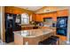 Well appointed kitchen featuring granite countertops, custom cabinets, and an island with barstool seating at 10952 S Desert Lake Dr, Goodyear, AZ 85338