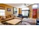 Inviting living room featuring warm colors, a large window for natural light, and comfortable seating arrangements at 10952 S Desert Lake Dr, Goodyear, AZ 85338