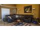 Spacious living area featuring a sectional sofa, warm tones, tile floors and recessed lighting at 10952 S Desert Lake Dr, Goodyear, AZ 85338