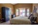 Serene bedroom with plush bedding, bay window view and plenty of natural light at 10952 S Desert Lake Dr, Goodyear, AZ 85338