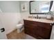 Charming powder room featuring wainscoting, a dark wood vanity, and granite countertops at 1132 E Sheffield Ave, Chandler, AZ 85225