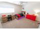 Inviting bedroom with desk, vibrant red dresser, carpet and modern lighting at 1132 E Sheffield Ave, Chandler, AZ 85225