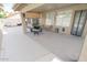 View of the outdoor covered patio including outdoor furniture, an exterior door and backyard at 1132 E Sheffield Ave, Chandler, AZ 85225