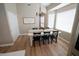Cozy dining area with natural light, chandelier, and modern table with seating for six at 1132 E Sheffield Ave, Chandler, AZ 85225