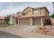 Two-story home showcasing a spacious three-car garage, neutral color palette and well-kept landscaping at 1132 E Sheffield Ave, Chandler, AZ 85225
