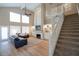 Spacious living room with high ceilings, fireplace, large windows, and staircase in an open floor plan at 1132 E Sheffield Ave, Chandler, AZ 85225