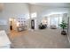 A spacious room with high ceilings, hardwood floors, large windows and a piano at 1132 E Sheffield Ave, Chandler, AZ 85225