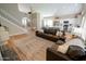 Open-concept living area with a staircase, eat-in kitchen, and comfortable seating arrangement at 1132 E Sheffield Ave, Chandler, AZ 85225